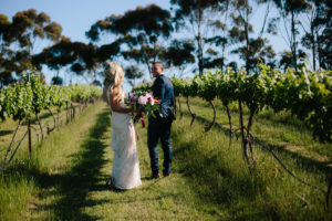 Happy Couple holding Bouquet in St Anne's Winery