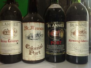 Four old bottles, with the St Anne's port brand on them: Colonial POrt, Port, Myrniong, and shiraz-cabernet
